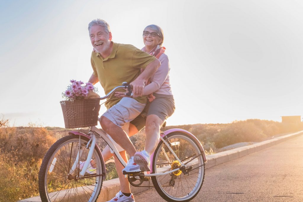 happy-elder-couple-on-a-bike-for-two-people