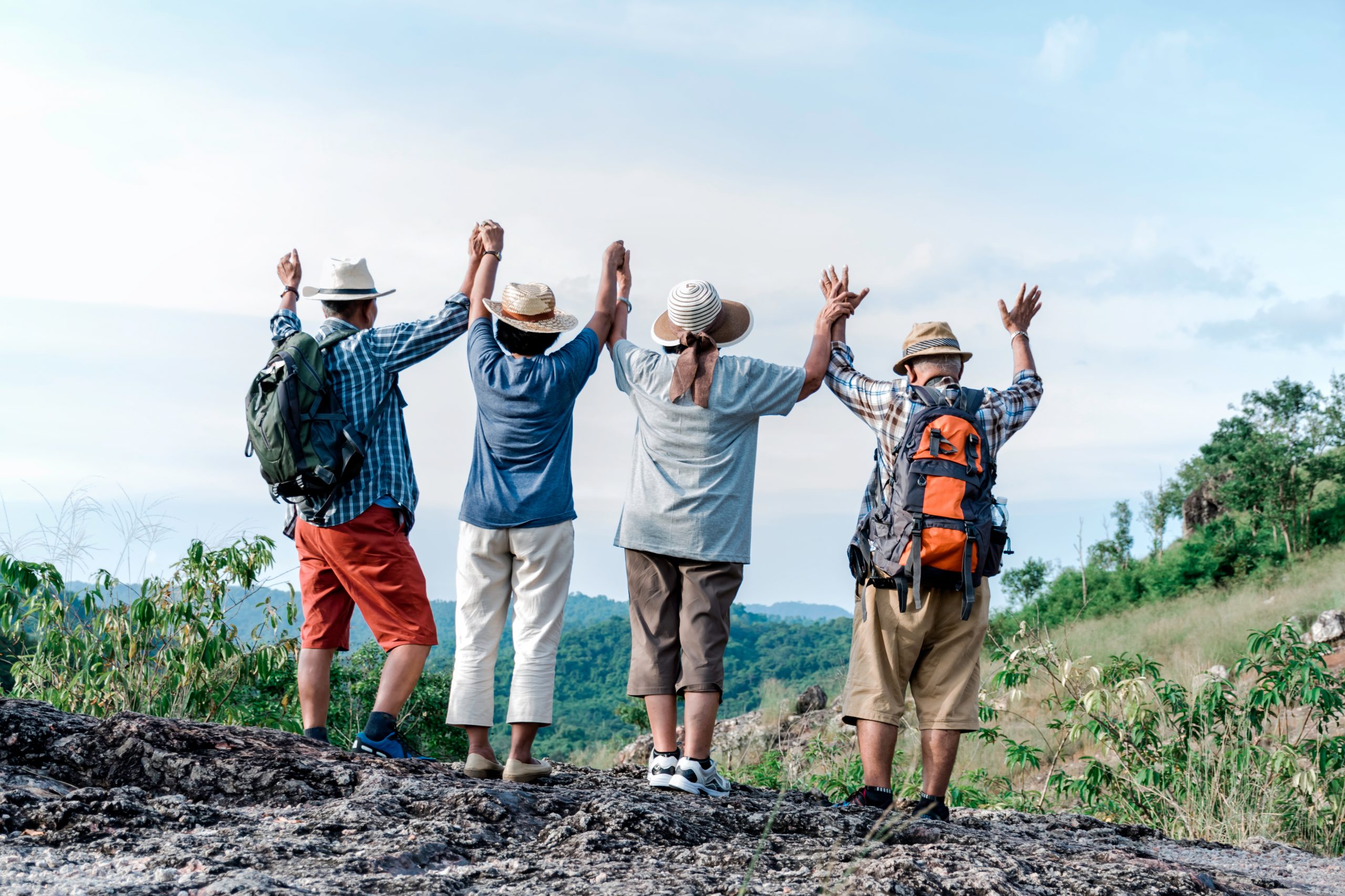 group-of-elders-travellers-holding-hands-in-the-air