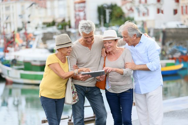 group-of-elders-travellers-holding-tablet